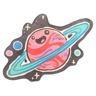 Saturnina (Nina), an original JoP character depicted as a cartoon planet with a round pink body, swirling red and violet surface patterns, and a wide blue-to-teal ringed orbit band passing diagonally across the figure; the face consists of two large black curved eye shapes and a small open expressi…