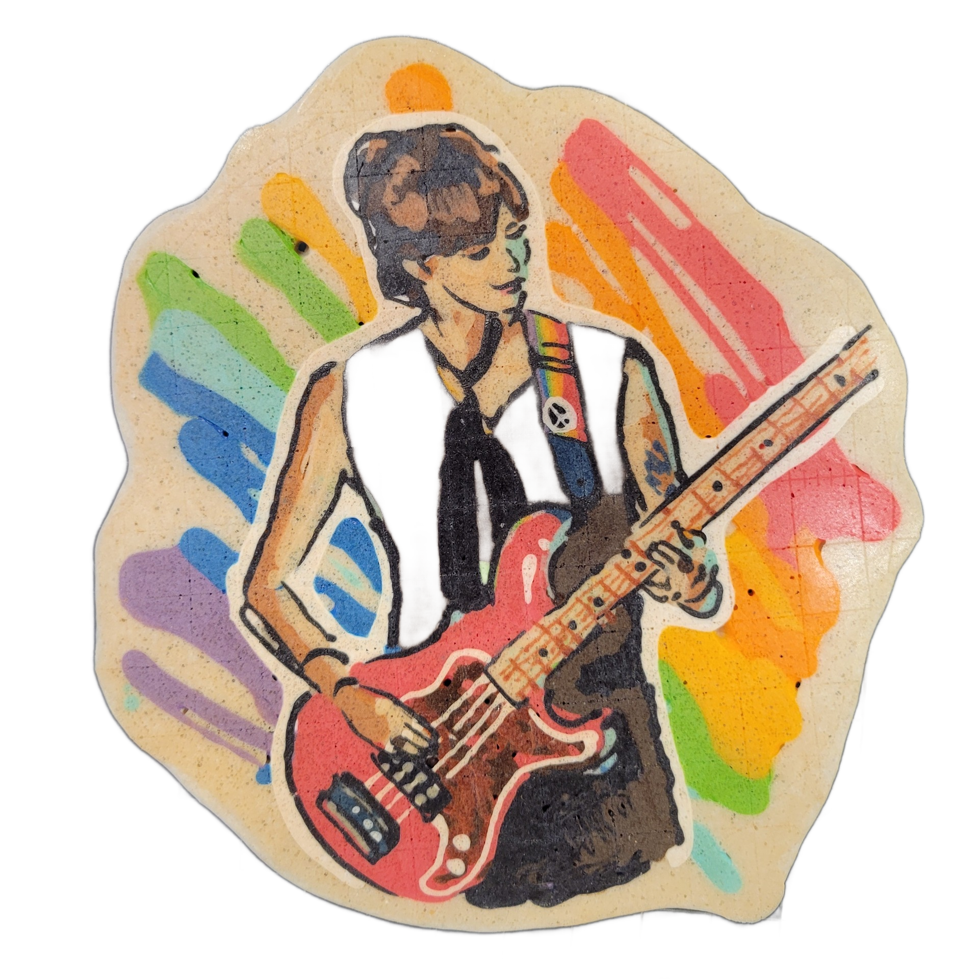 Pancake art depicting a figure named Nikko, shown from roughly the waist up, holding a red electric guitar with a maple-colored neck; the figure has short brown hair, wears a dark sleeveless top with a small circular pin on the chest, a dark neck tie or scarf, and has visible tattoos on one arm, wi…