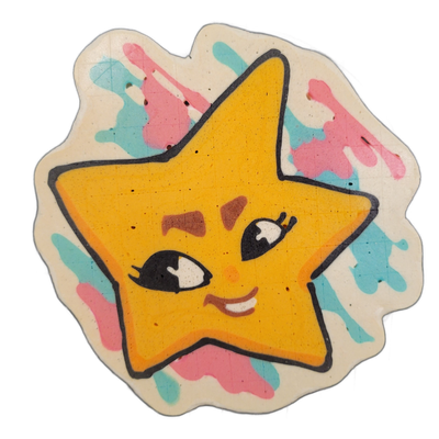Pancake art depicting Charli, a JoP original character designed as a sentient five-pointed star with a cartoon face featuring large expressive eyes with lashes, rosy cheek marks, and a small open smile showing teeth, set against a cream-colored irregular background splashed with loose drips and blo…