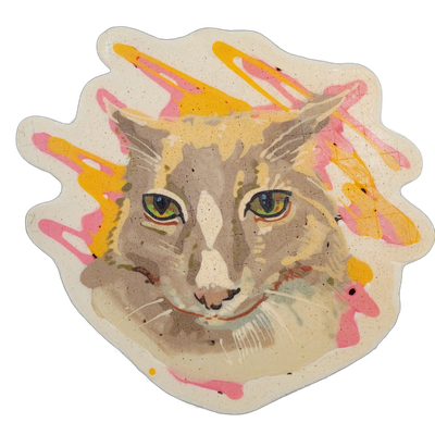 Pancake art portrait of a cat named Matcha, depicted from the neck up, facing forward, with green and blue-toned eyes, a white blaze on the forehead and nose bridge, and short white whiskers rendered in fine lines. The piece uses bold outlines around the face with layered batter in tans, grays, and…