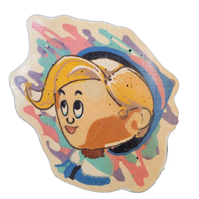 Pancake art portrait of Hermie, a cartoon-style character with a round face, large dark eyes, a small open smile, and blonde hair swept back inside a round dark-rimmed circular frame that resembles a helmet or headgear visor; a small hand or paw is visible curled near the lower right of the face, a…