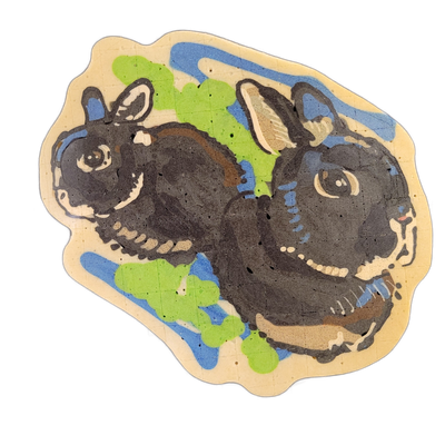 Two dark-furred rabbits face opposite directions against a background of blue and bright green shapes, with cream-colored negative space defining the outer border; the rabbit on the left faces left and is shown in full profile, while the rabbit on the right faces right and is shown from the shoulde…