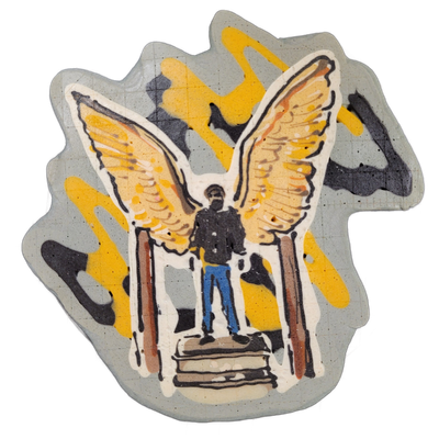 Pancake art of a figure titled 'Angel of Justice,' depicted standing upright on a stacked rectangular pedestal with two vertical posts flanking the base, wearing blue jeans and a dark jacket, with large outstretched wings rising symmetrically from the shoulders. Rendered by Dan with bold black outl…