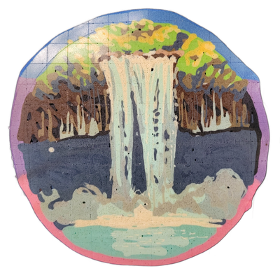 A circular pancake art piece depicting a large waterfall cascading down a rocky cliff face into a pool below, with dense tree canopy in green, yellow, and brown tones along the top edge and mist or foam rendered in off-white at the base of the falls. The piece uses bold color blocking with fine bat…
