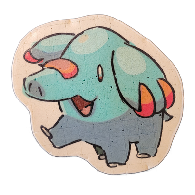 Pancake art depicting Phanphy, a small elephant-like cartoon character with a round, teal-blue body covered in lighter circular spots, gray legs and face, and orange-to-red gradient ear flaps shown on both sides of the head, with an open mouth revealing a pink tongue and a single visible eye. Rende…