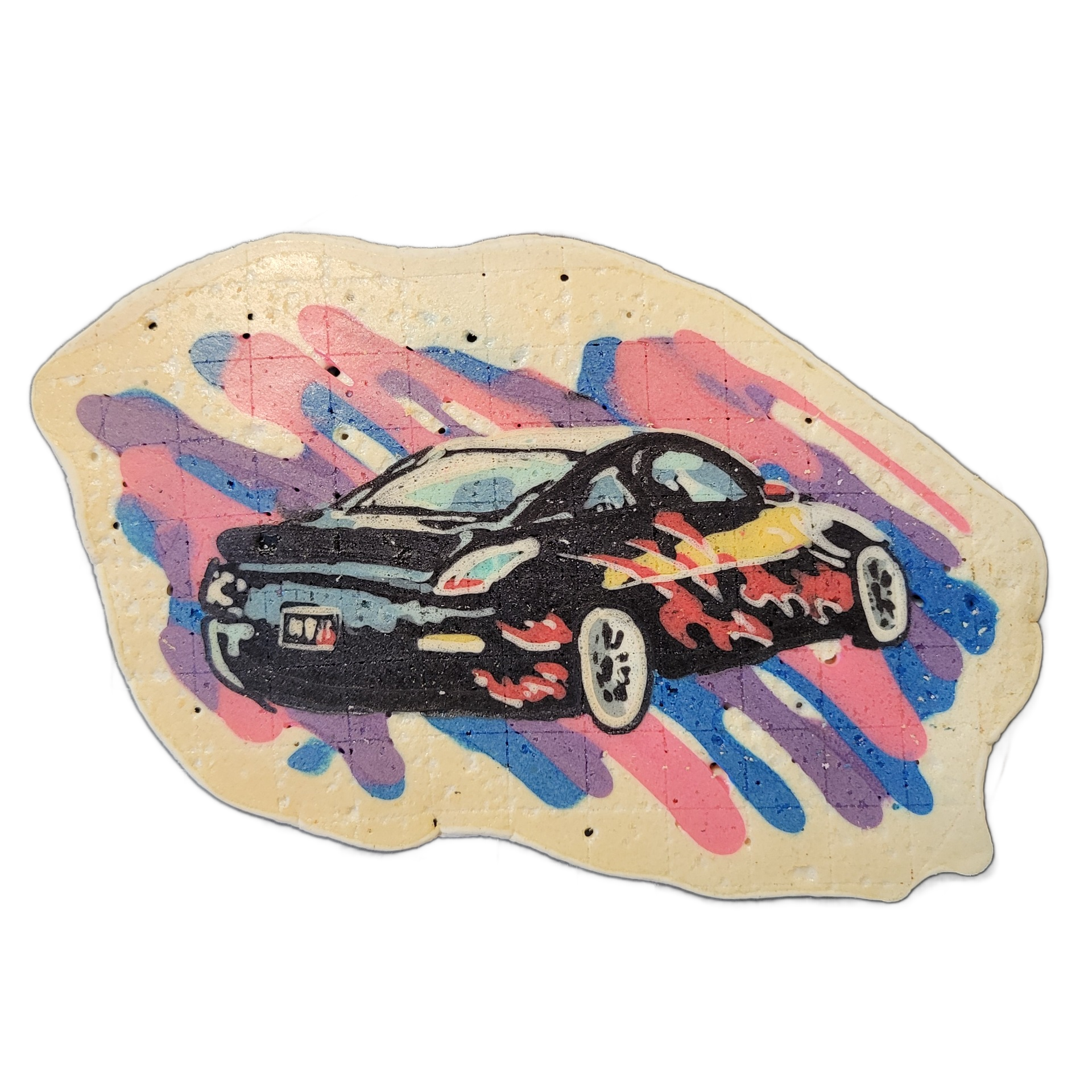 Pancake art of a black low-profile car with flame graphics along its lower body, shown in a three-quarter front-left view against a background of diagonal paint-stroke shapes in pink, blue, and purple on a cream-colored irregular base. The car is rendered with bold black outlines and white highligh…