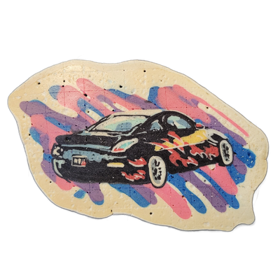 Pancake art of a black low-profile car with flame graphics along its lower body, shown in a three-quarter front-left view against a background of diagonal paint-stroke shapes in pink, blue, and purple on a cream-colored irregular base. The car is rendered with bold black outlines and white highligh…