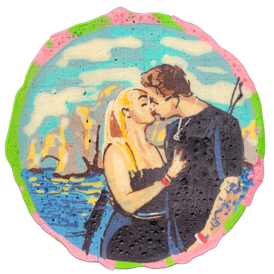 A couple named Elexis and Devin, depicted from approximately the waist up, kissing; Elexis has long blonde hair and wears a dark spaghetti-strap top and has a red wristband, while Devin has short brown hair, wears a dark long-sleeve top, and has a visible tattoo on one forearm, with rocky sea stack…