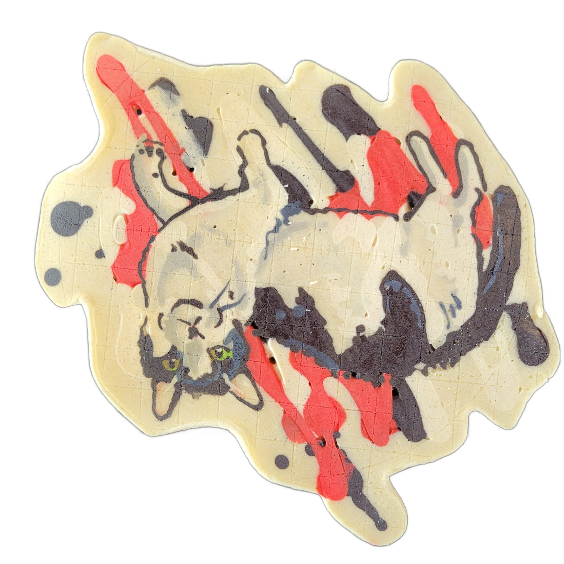 Pancake art of a cat named Juliette, depicted lying on its back in a relaxed pose with its head turned toward the viewer and green eyes visible. The piece uses fine dark outlines to define the cat's form against a cream-colored background, with bold drip-style streaks of red and dark purple-gray ba…