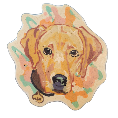 A pancake art portrait of a dog's face, appearing to be a yellow or golden Labrador Retriever, shown from the front with floppy ears, dark expressive eyes, a black nose, and a collar visible at the bottom of the composition, surrounded by abstract paint-splash shapes in pink, orange, and teal on a…