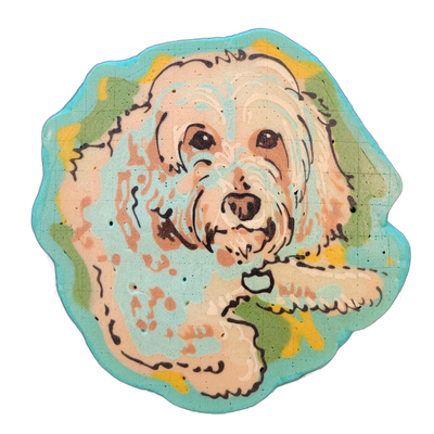 Pancake art portrait of a fluffy, light-coated dog named Daisy, shown from roughly the chest up, facing forward with a slight tilt, wearing a collar, with one paw extended toward the lower right; the dog appears to be a doodle-type breed with long, wavy fur around the face. Fine dark brown batter l…