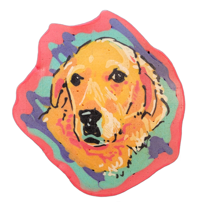 A pancake art portrait of a golden retriever's face and upper chest, centered and viewed straight on, with floppy ears framing a broad muzzle, dark eyes, and a large black nose. It is rendered with bold black outlines over fill areas of yellow, orange, coral, and pink for the dog, set against a bac…
