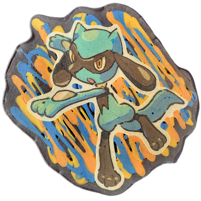 Pancake art depicting Riolu, a bipedal canine Pokémon character, shown in a dynamic crouching or lunging pose with one arm extended forward and the other raised, rendered with a white outline border around the figure against a dark background with diagonal streaks of orange, yellow, and blue batter…