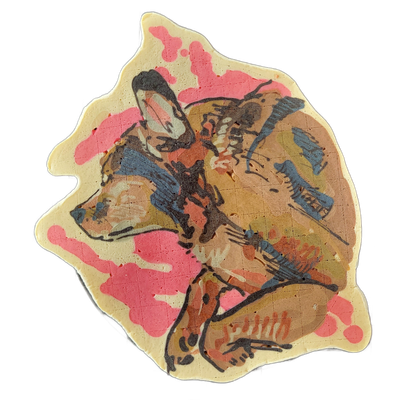 Pancake art depicting a dog named Maddie, shown in a curled or resting pose with the head turned to one side and limbs visible beneath the body. The piece uses bold black outlines over areas of warm tan, muted olive, rust, and slate blue, with a bright pink splashed background; line work is loose a…