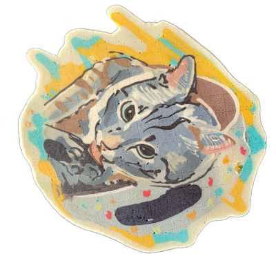 Pancake art of a cat named Finn, depicted in a curled or resting pose with the head turned to face forward, showing both eyes, striped markings across the face and body, and pink inner ears. The piece uses bold black outlines with blue-gray and tan fill colors on the subject, set against a backgrou…