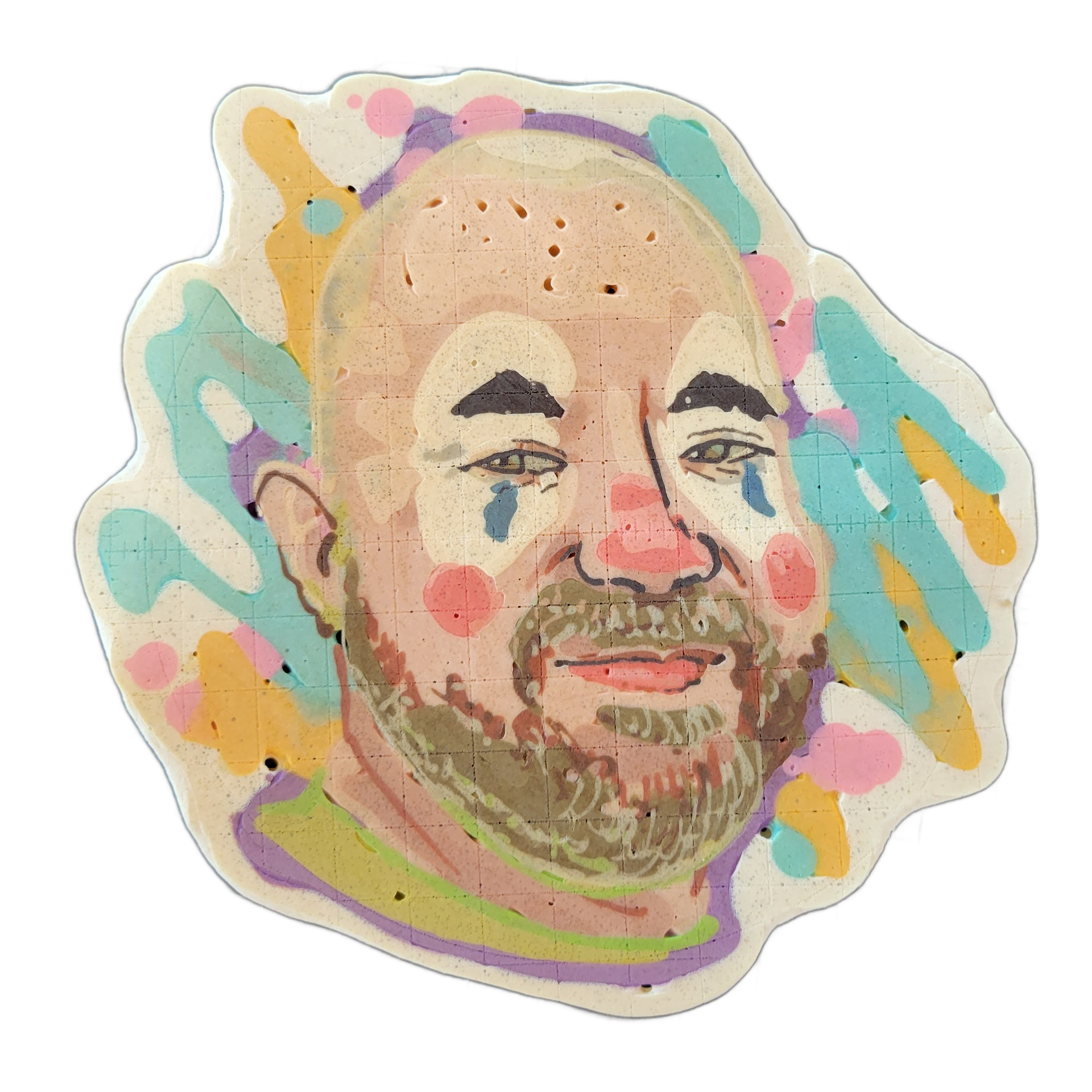 Pancake art portrait of Rodeo Clown Matt, depicting a bald man with a full beard, dark arched eyebrows, and light-colored eyes, rendered with pink cheek circles, blue teardrop marks beneath each eye, and a red nose circle in a clown-makeup style. The piece uses fine batter lines for facial detail a…