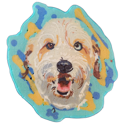 Pancake art portrait of a dog named Max, shown from the front with a light cream and tan coat, a dark nose, an open mouth with a visible pink tongue, one brown eye, and one eye with mixed blue and brown coloring. Rendered by Dan using fine white batter lines for fur texture over broader fill areas,…