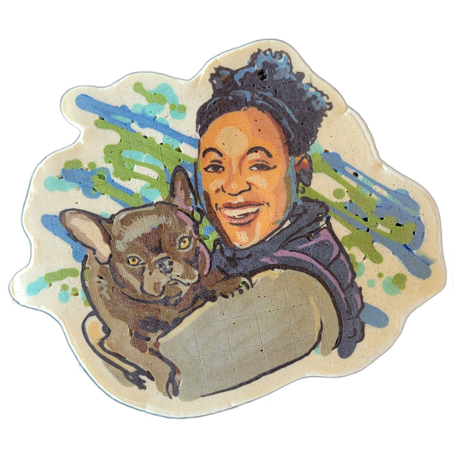 Pancake art depicting a smiling woman with natural hair pulled up, holding a small dark-coated French Bulldog close to her chest; the background features loose diagonal streaks and paint-splatter-style shapes in blue, teal, and green. The piece uses bold outlines throughout, with warm amber and bro…