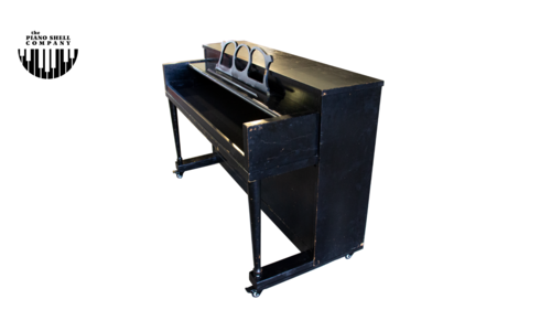 An upright piano shell prepared for the stage, studio or home