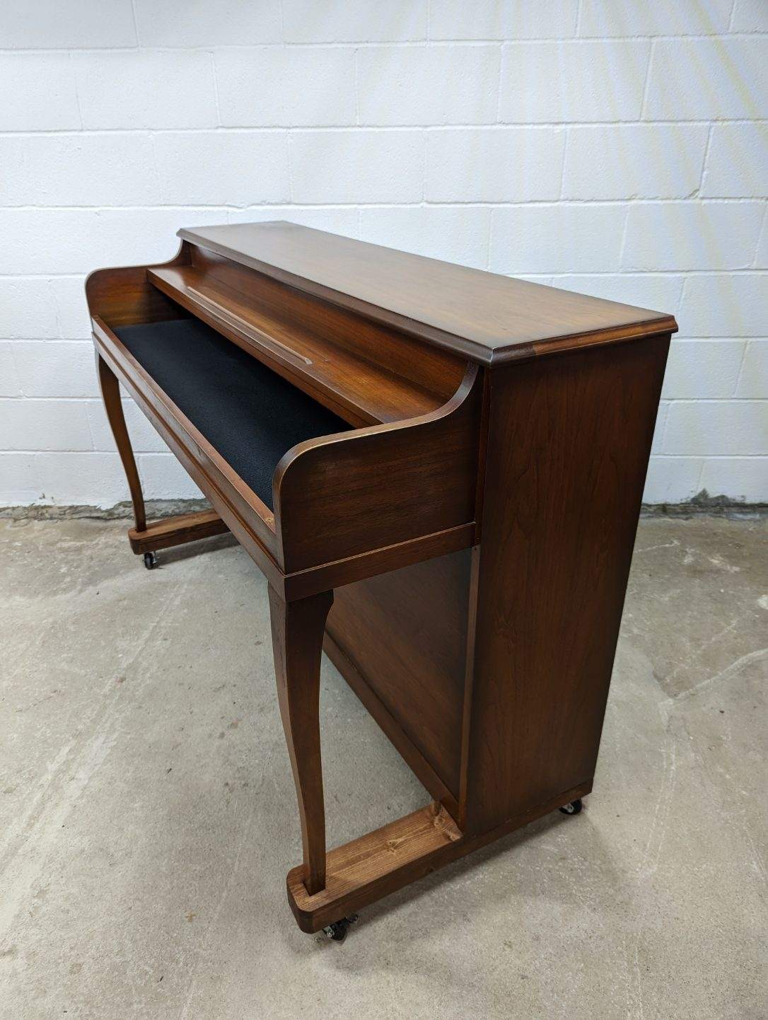 An upright piano shell prepared for the stage, studio or home