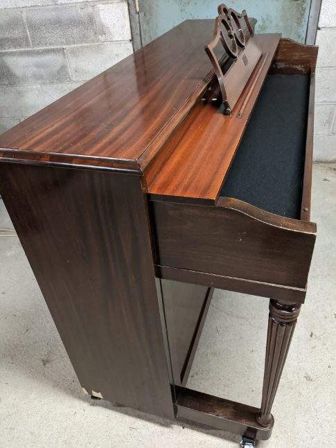 An upright piano shell prepared for the stage, studio or home