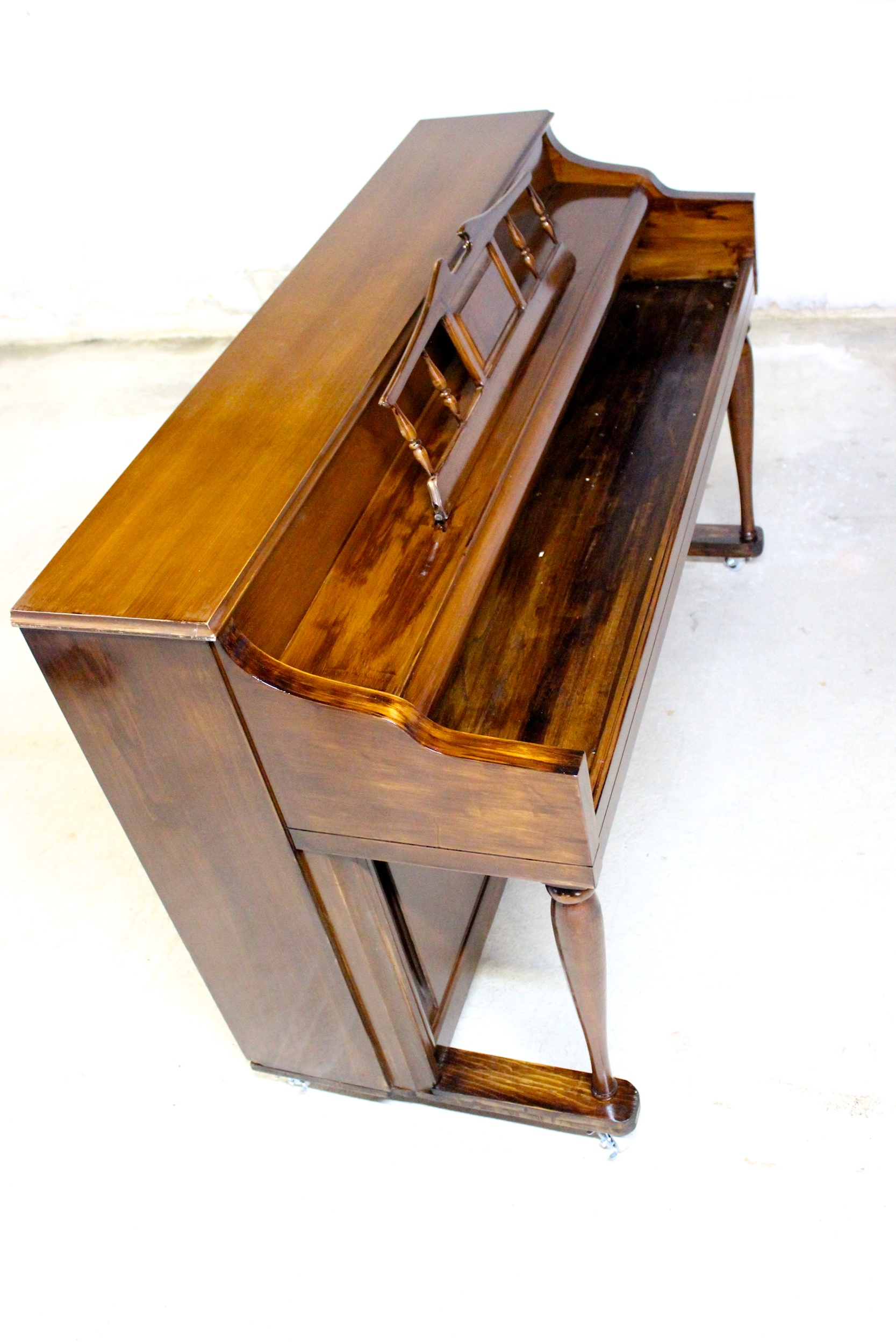 An upright piano shell prepared for the stage, studio or home