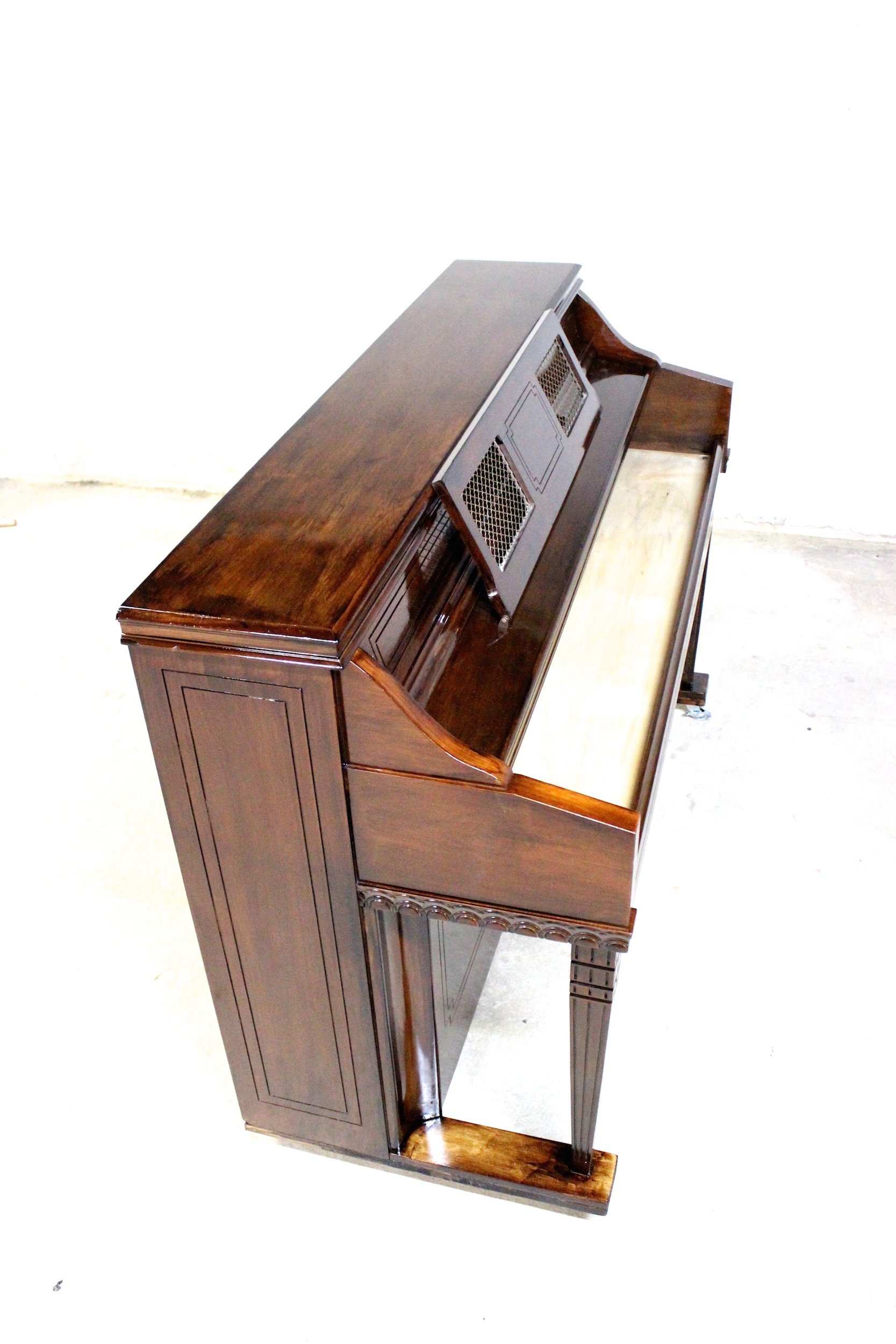 An upright piano shell prepared for the stage, studio or home