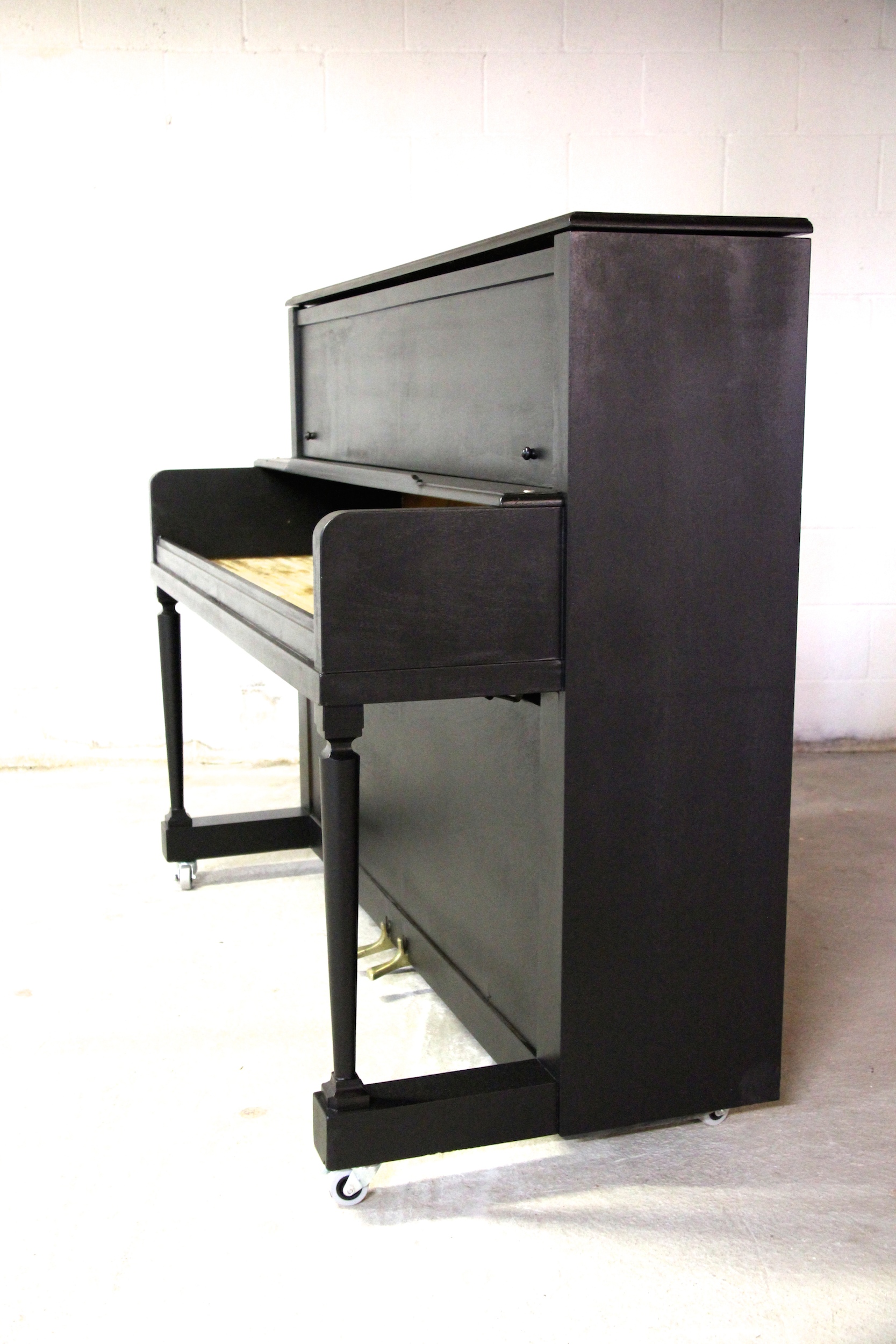 An upright piano shell prepared for the stage, studio or home