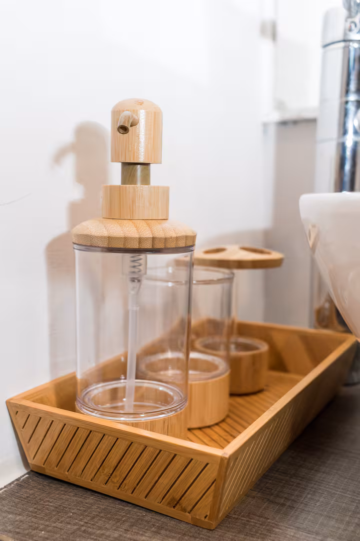 Wooden bathroom accessories in a small basket.
