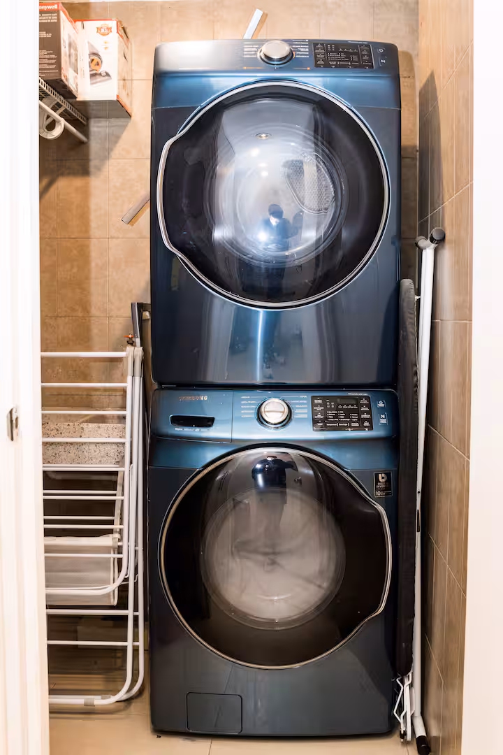 Stacked washer and dryer in a laundry nook.