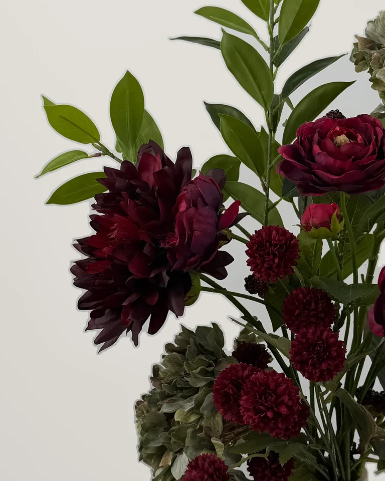 Detail van de burgundy dahlia en donkerrode Gompy-bloemen in boeket Rubina