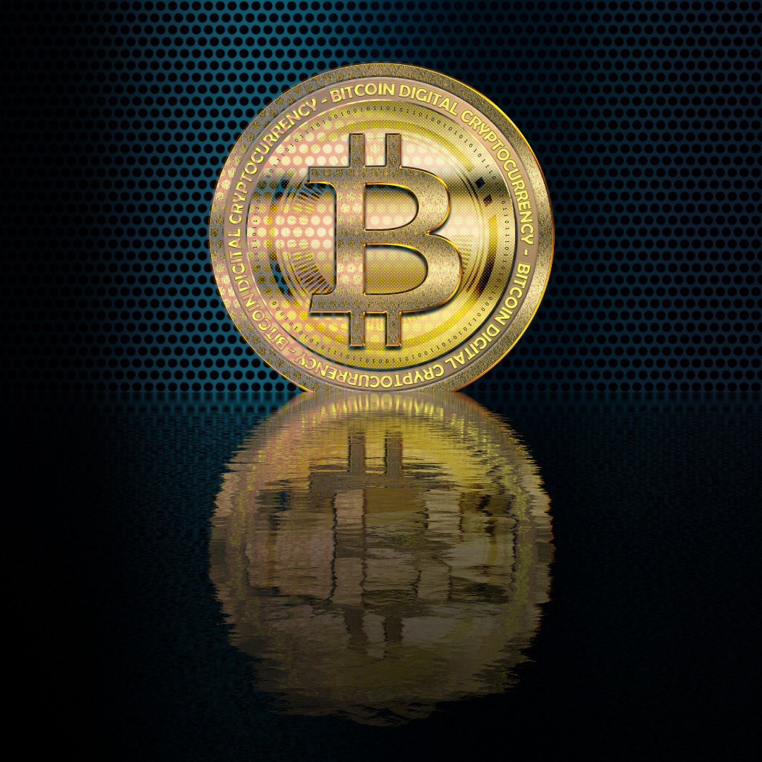 gold bitcoin coin reflecting on dark metallic background
