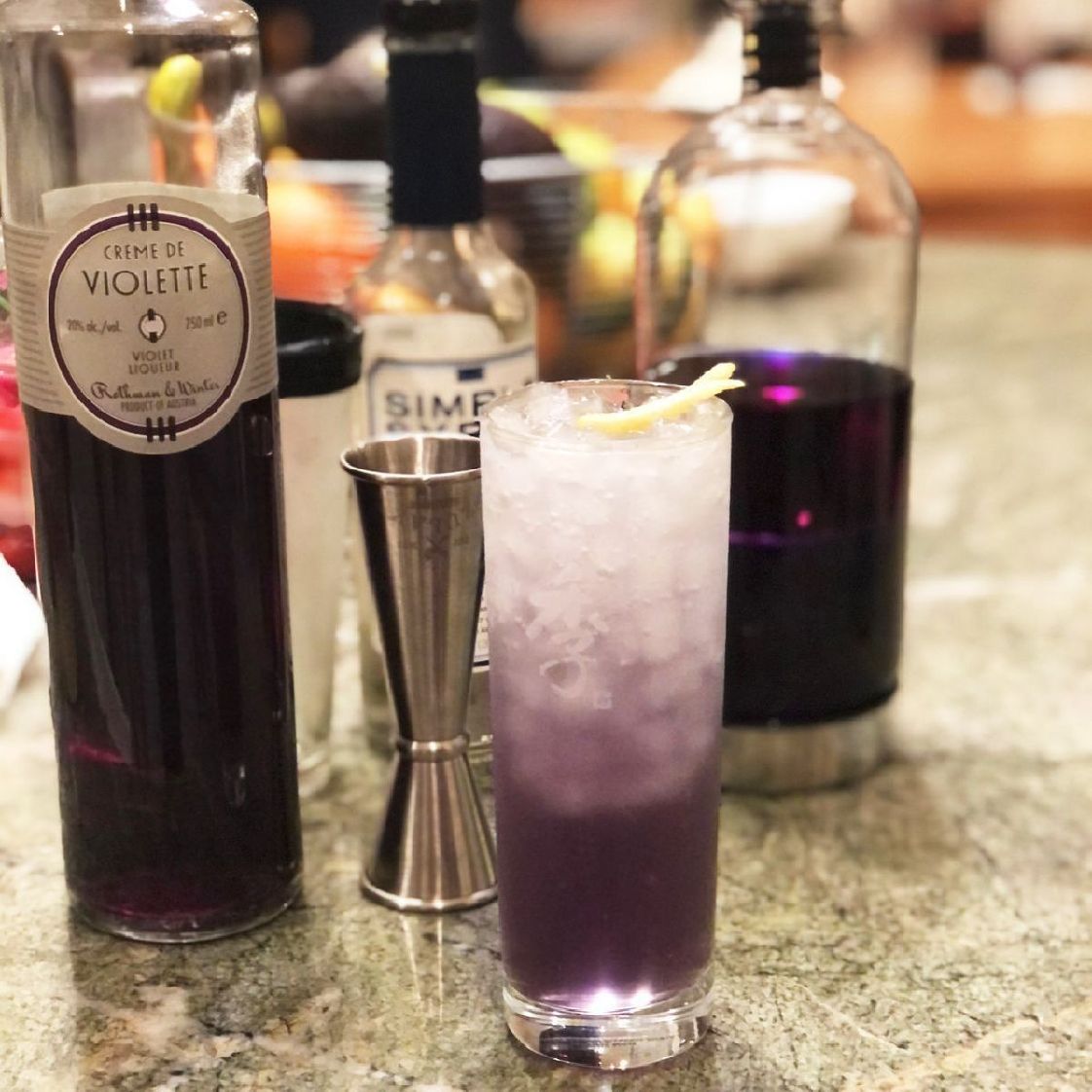 One of the first cocktails I ever loved was the Violet Fizz, which I regularly ordered when I lived in Japan -- and here's the scandalous part -- when I was fifteen! I went to high school on the Navy base, but in Japan, off-base, alcohol was freely available without ID. Teenagers didn't have to drink in secret places, either. We could hold our heads up high in proper nightclubs and order fancy cocktails with abandon. And the Violet Fizz was my drink of choice.
 
Until a few years ago, it was really difficult to find crème de violette. My sister would bring it back for me when she visited Europe, and it was such a luxury! But now, it's fairly easy to get, and therefore a reliable favorite when I'm mixing something up.
 
One thing I noticed when I started making Violet Fizzes at home was the color was never as intense as it was in Japan. I have a bottle of the very rare Hermes Violet by Suntory that I brought home from a visit to Japan a few years ago, and that produces a more familiar hue, but I'm terrified of using it up! So I use the Rothman & Winter Crème de Violette, which is lovely and fine. But this time I decided to infuse my Bombay Sapphire with butterfly pea flowers to create an intensely purple base. And it worked! If you're as attracted to purple drinks as I am, you'll see this is an enormous victory!
