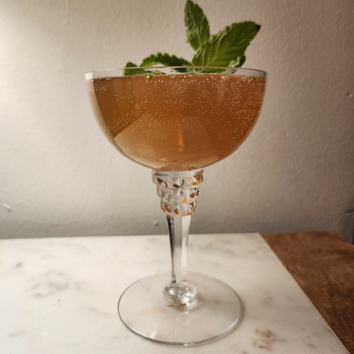 A Mojito made with dark rum and topped with sparkling wine