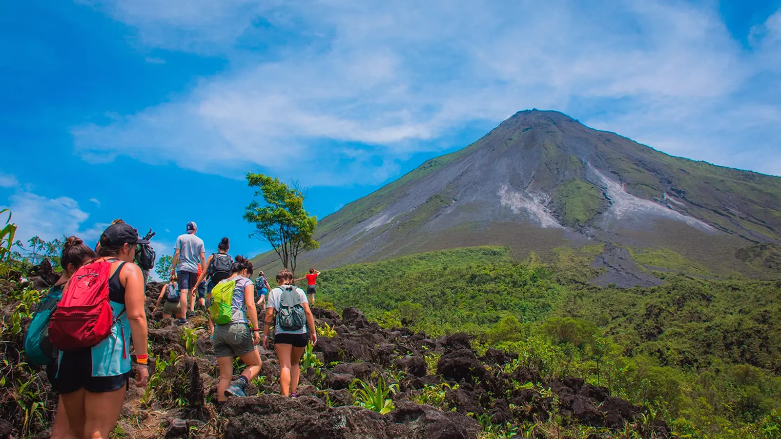 Travelers ascending Arenal Volcano on a guided hike