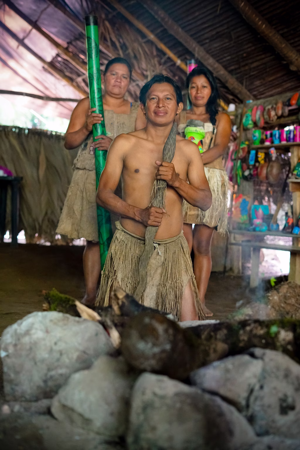 Maleku family displaying traditional clothing and artifacts during the cultural experience.