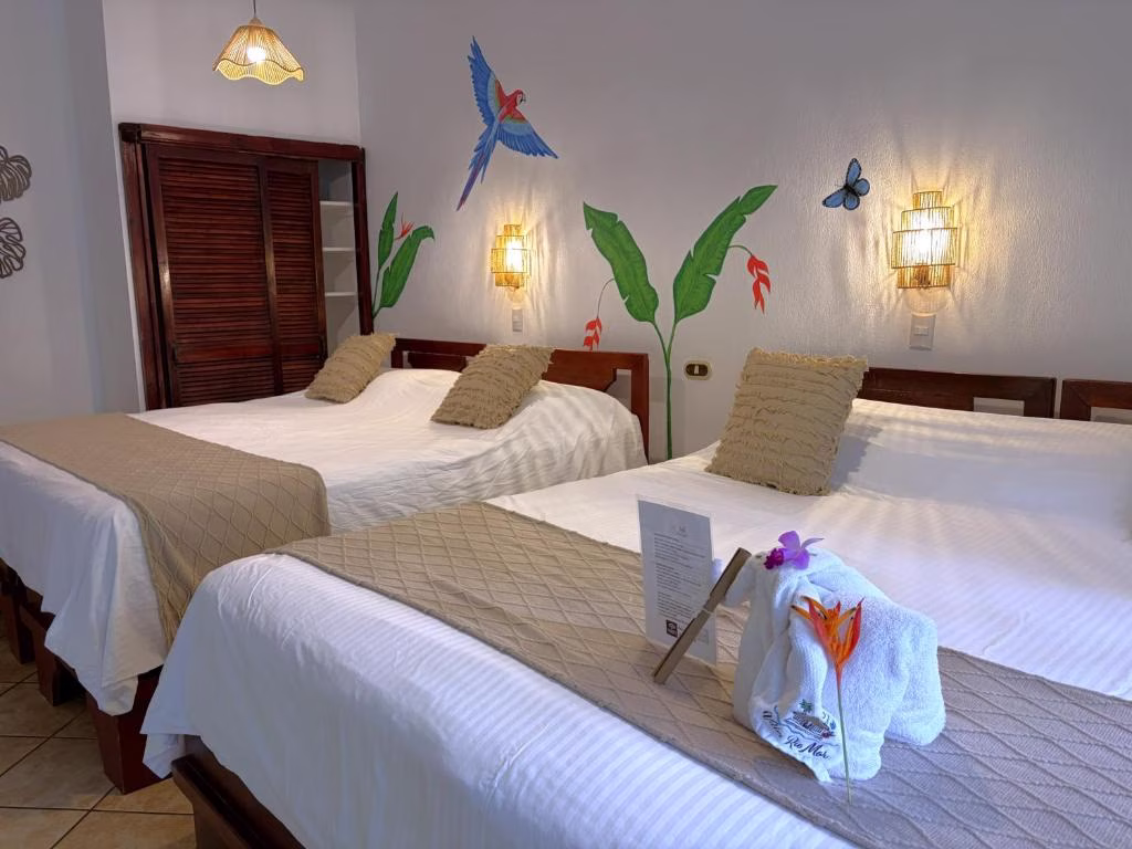 Spacious Double King Deluxe Room at Villas Río Mar in Dominical, Costa Rica, featuring two king beds