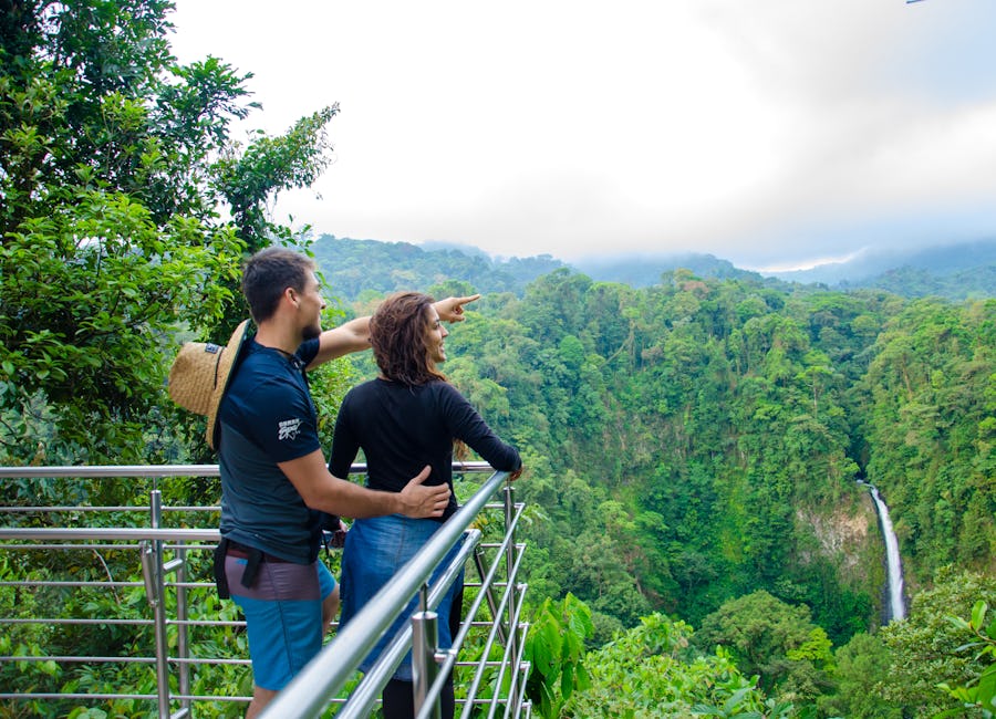 Couple admiring scenic views from a lookout point in La Fortuna Waterfall Reserve, San Carlos, Costa Rica