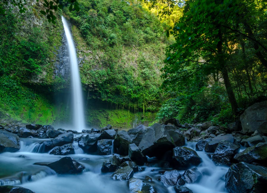 La Fortuna Waterfall cascading over rocks into the river below in La Fortuna, San Carlos, Costa Rica