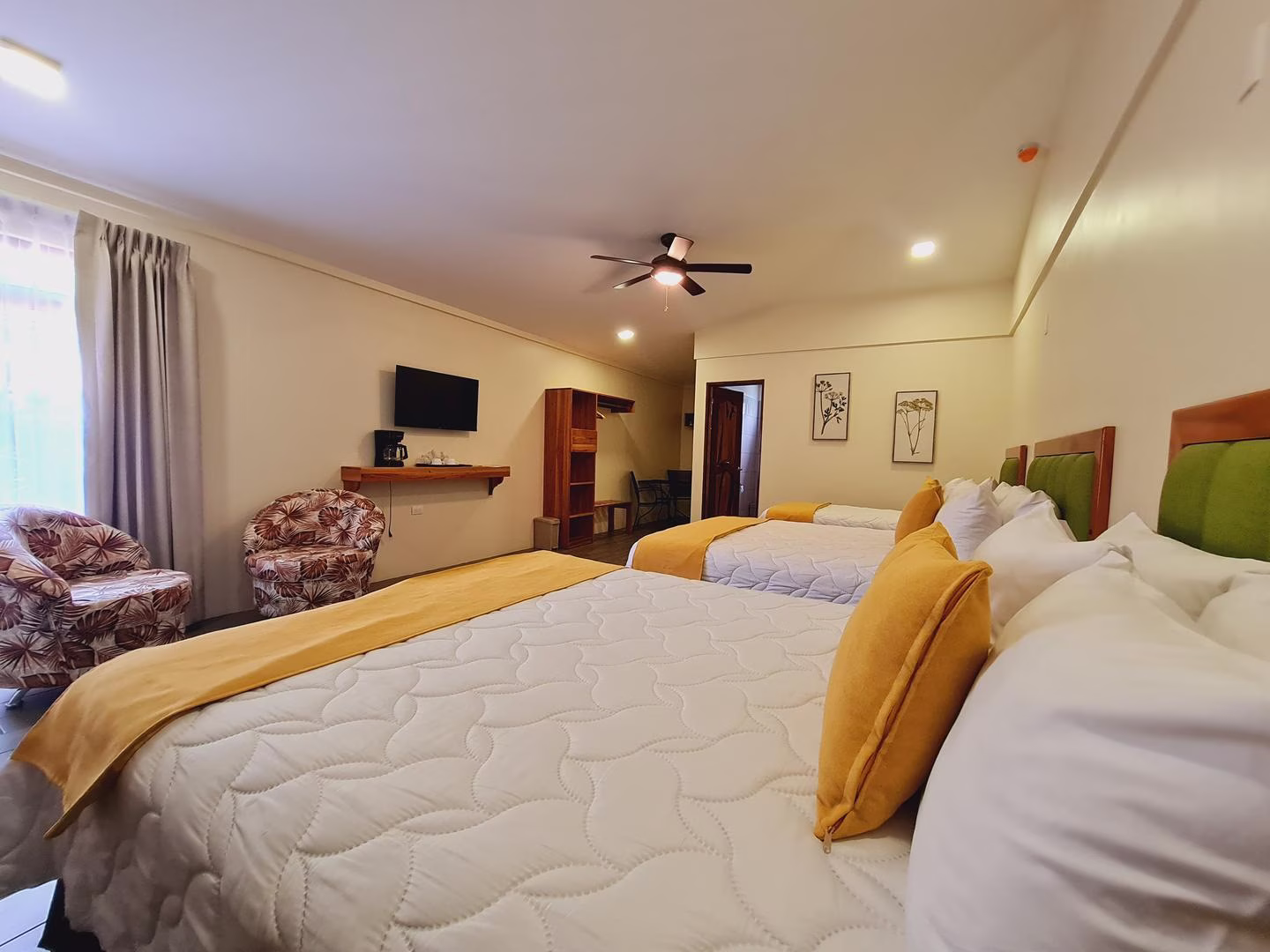 Guaria family room for five guests with two queen beds and one single bed at Sibu Boutique Hotel in Monteverde, Costa Rica