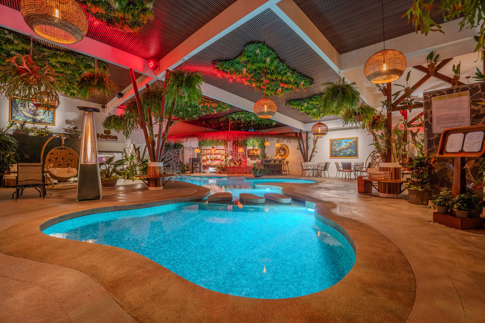 Wide night view of indoor pool at Sibu Boutique Hotel