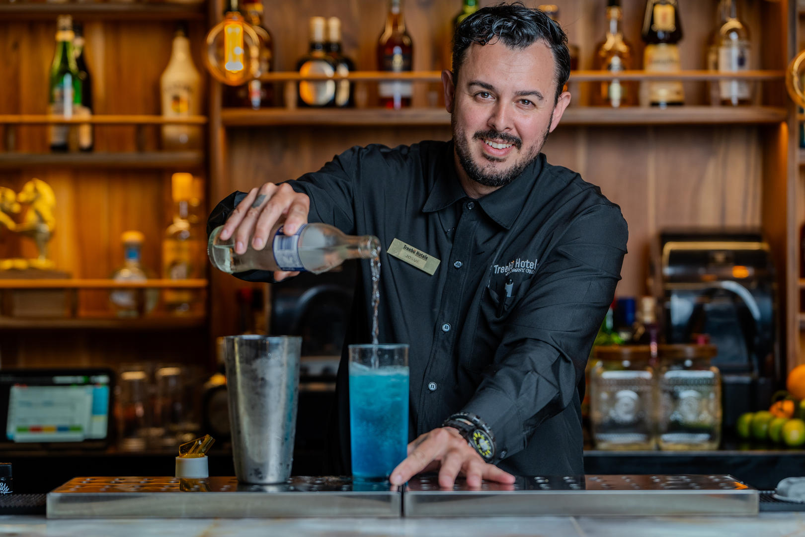 Bartender preparing drinks while smiling at the camera at Hotel & Spa Poco a Poco, Monteverde