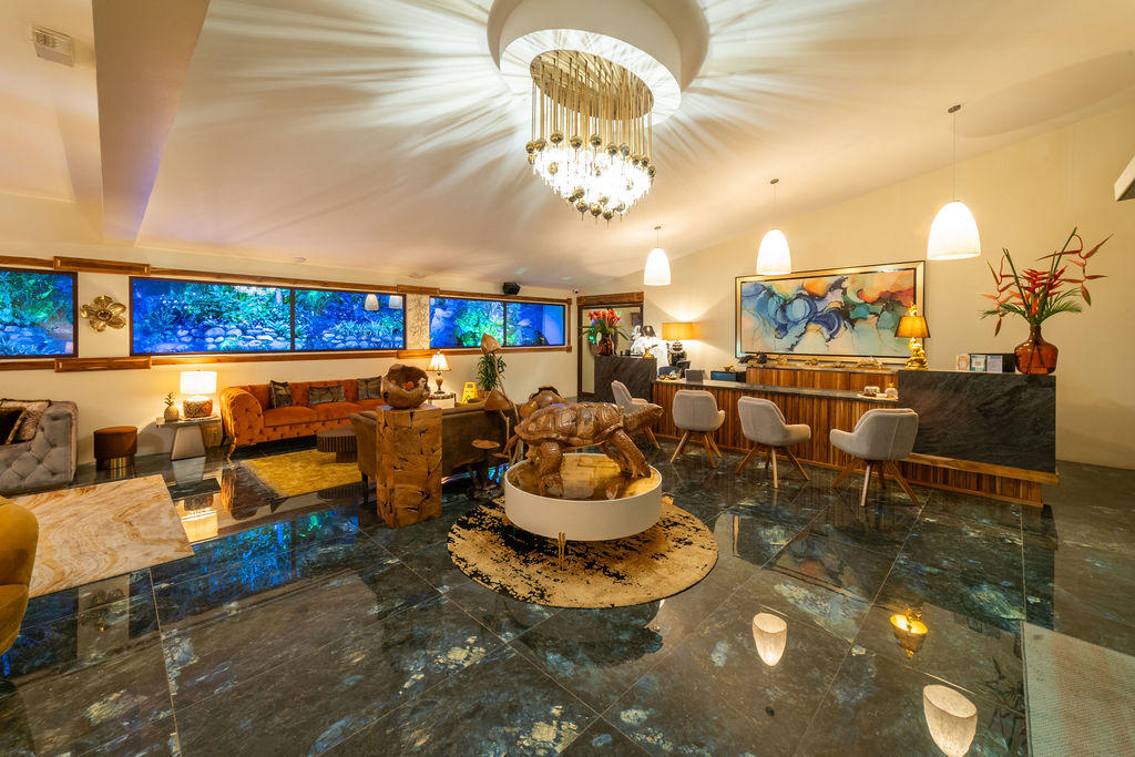 Lobby corner view featuring a wooden turtle sculpture and elegant seating area at Hotel & Spa Poco a Poco, Monteverde