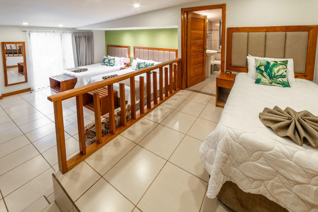 Full view of Garden Family Room showing king, queen, and single beds at Hotel & Spa Poco a Poco, Monteverde