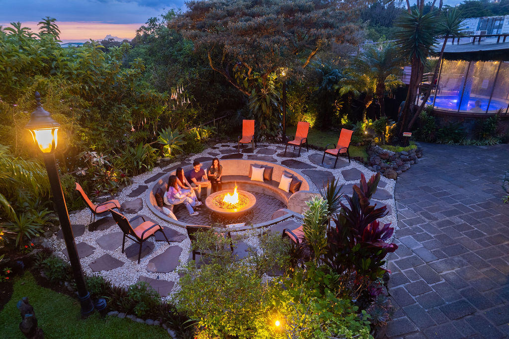 Elevated wide view of the fire pit area with a group of friends gathering at Hotel & Spa Poco a Poco, Monteverde