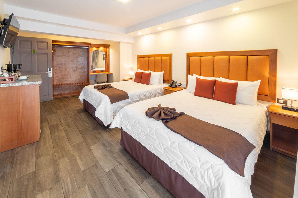 Quetzal Room with two queen beds and a spacious interior layout at Hotel & Spa Poco a Poco, Monteverde