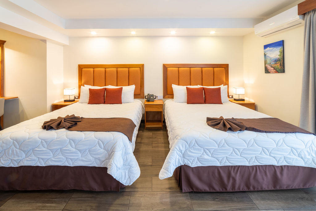 Quetzal Room with two queen beds and a spacious, comfortable layout at Hotel & Spa Poco a Poco, Monteverde