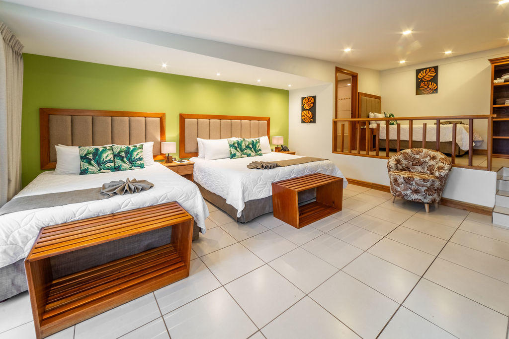 Corner view of Garden Family Room showing main beds and single bed across first and second level at Hotel & Spa Poco a Poco, Monteverde