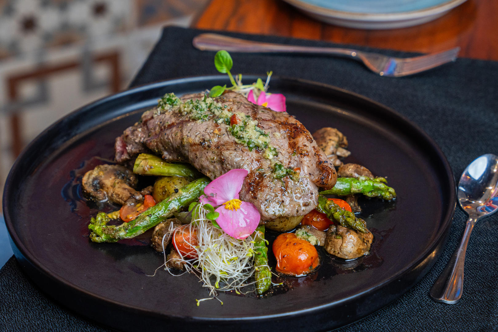 Gourmet plated dish featuring sliced steak with vegetables at Otocuma Restaurant, Hotel & Spa Poco a Poco, Monteverde