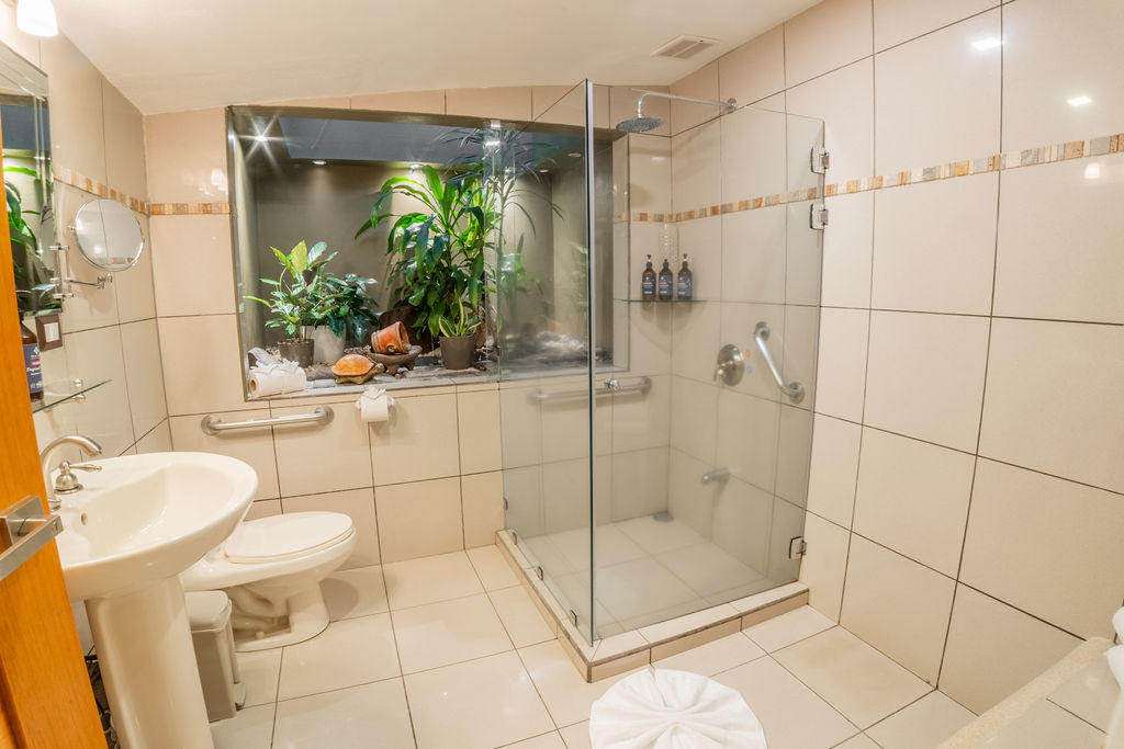 Contemporary bathroom in Garden Family Room with glass shower and terrarium detail at Hotel & Spa Poco a Poco, Monteverde
